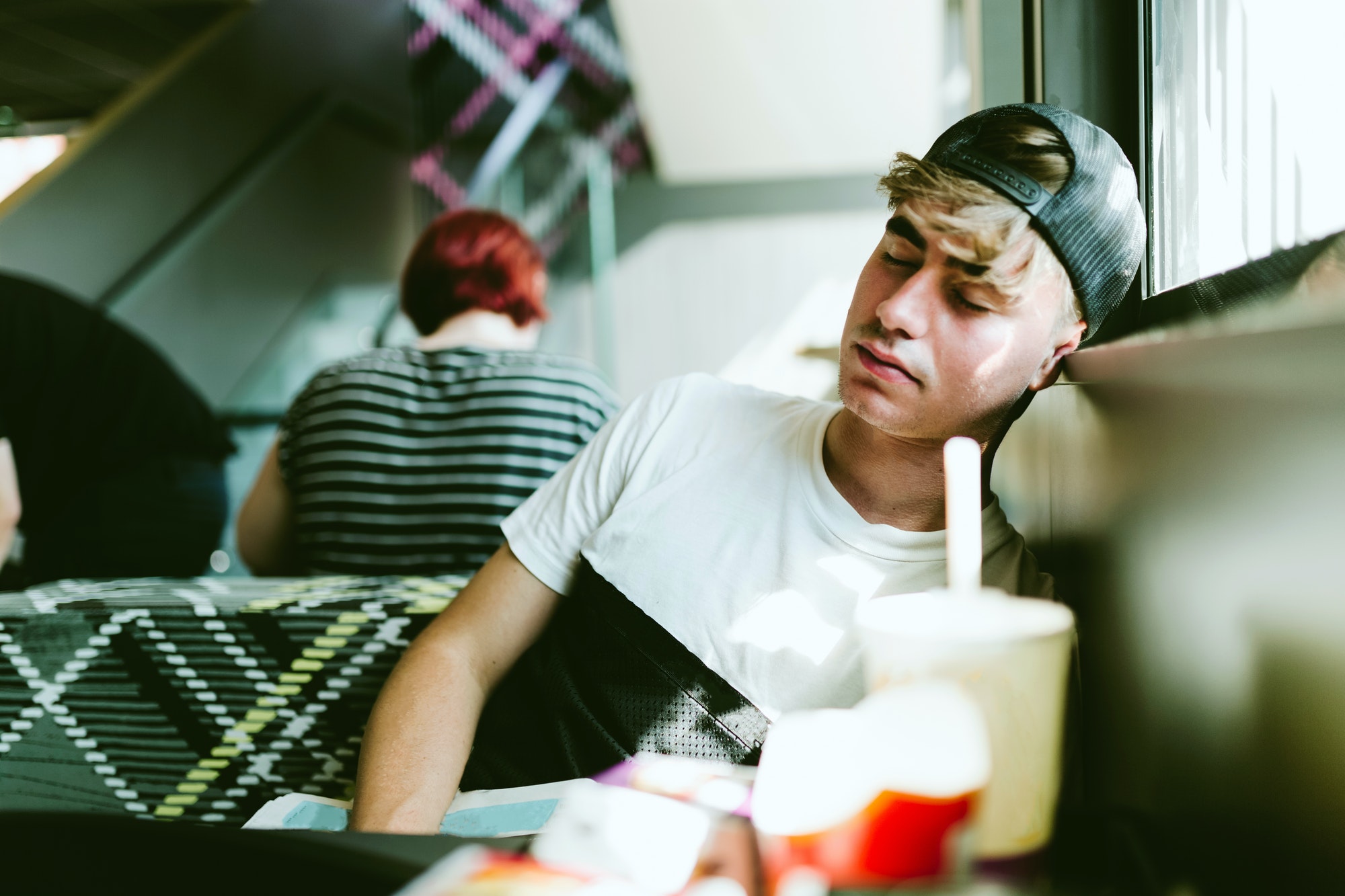 Handsome young man sleeping in the airport.