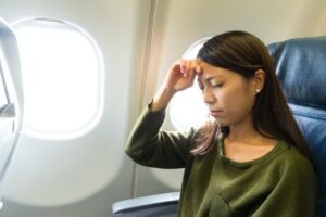 Woman suffer from headache inside airplane