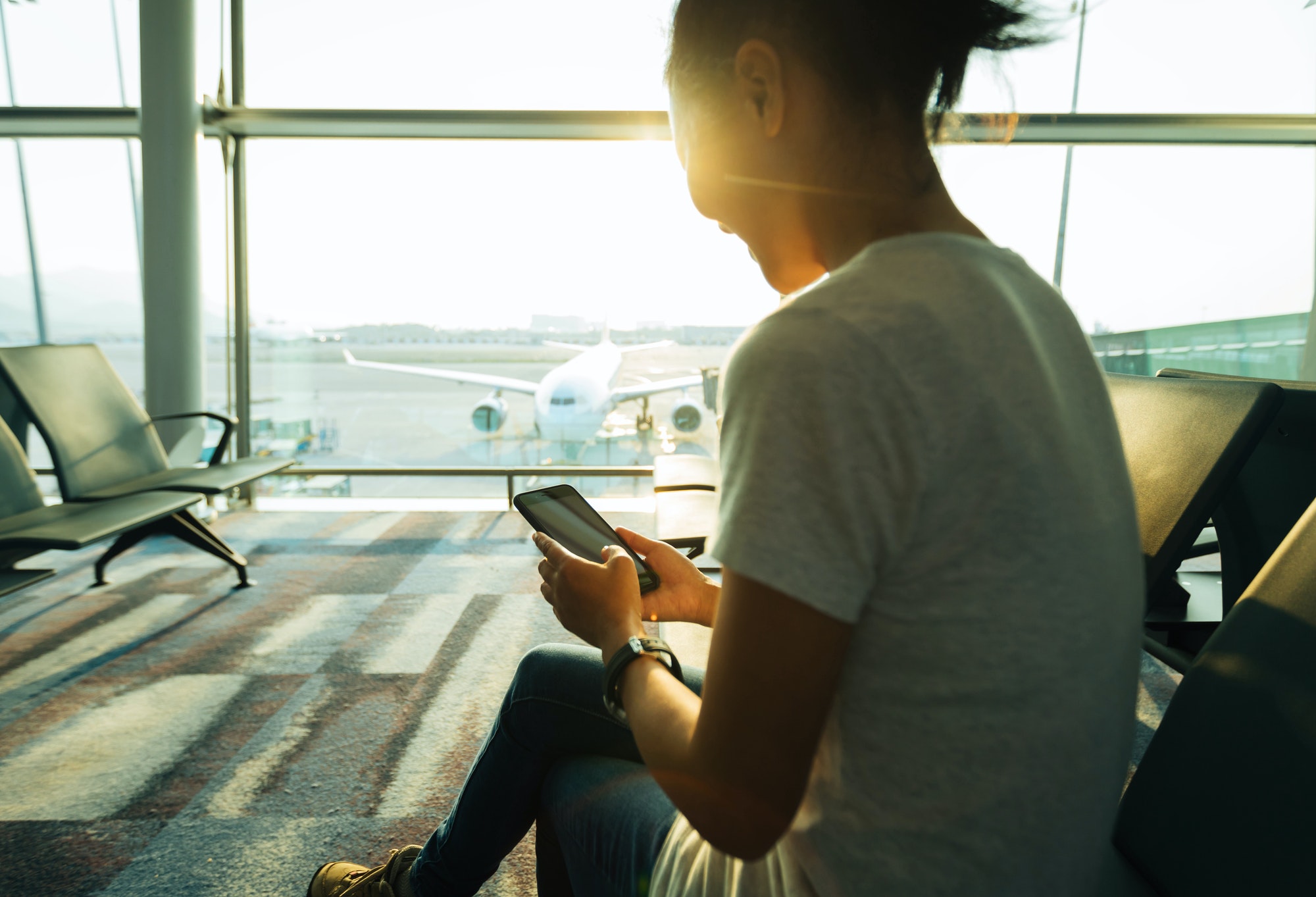 woman using cellphone in airport