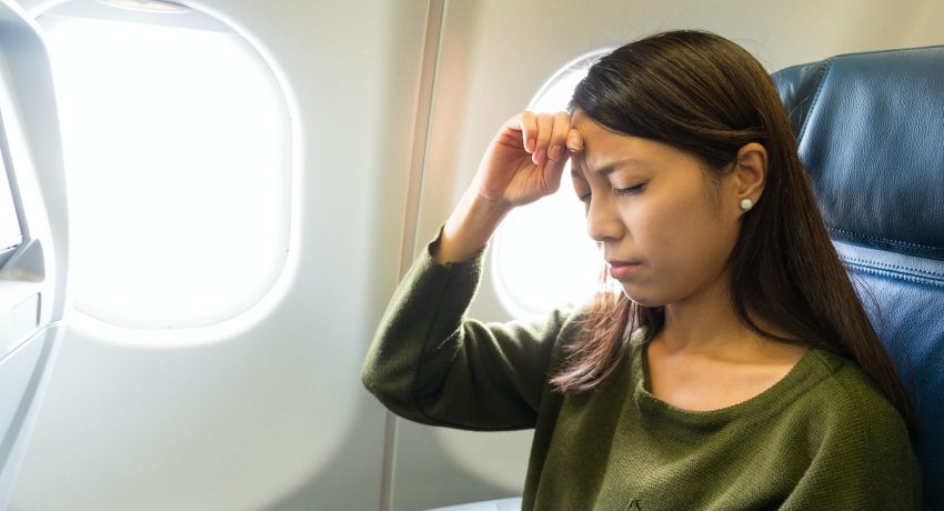 Woman suffer from headache inside airplane