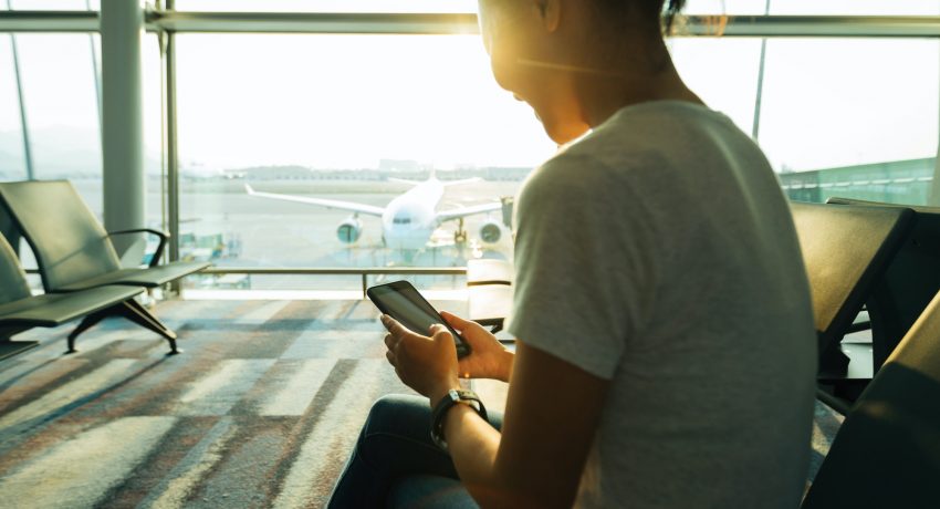 woman using cellphone in airport